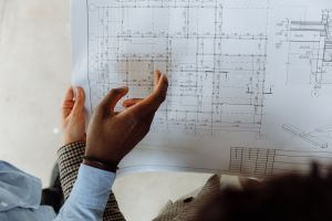 Hands pointing at architectural blueprints